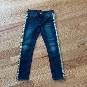 Justice jeans with gold sequins on side.